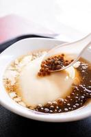 Popular Taiwan gourmet - Dessert of tapioca pearl ball bubble mixed bean curd tofu pudding douhua, dou hua in white bowl, close up, lifestyle photo