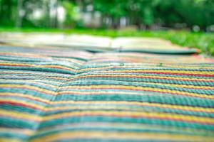 Asian mat on the grass ground in the outdoor park without people. photo