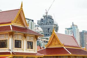 Thai temple in front of urban construction. Representative between religion and urban civilization building and construction are backround., Bangkok, Thailand. photo