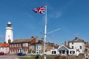 Southwold, Suffolk, UK, 2010. Union jack flag flying near the lighthouse in Southwold Suffolk on June 2, 2010. Four unidentified people. photo