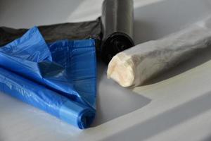 Plastic garbage bags in rolls on a white background photo