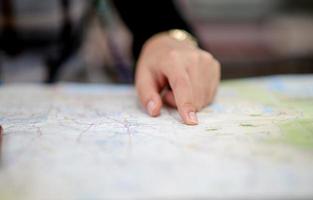 Hand and map of tourists trekking for accuracy. photo