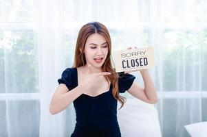 Women and shop closing signs Concept of closing and canceling business photo