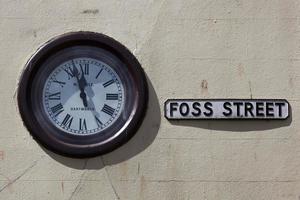 DARTMOUTH, DEVON, UK, 2012. Clock on the wall in Foss Street Dartmouth on July 28, 2012. photo