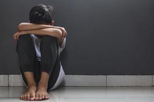 Sad children squat at home after get punished by parent photo