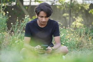 man using mobile in park photo