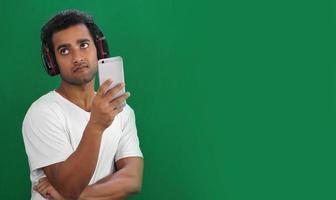 Young man using mobile phone but not happy photo