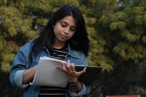 College student writing something on her notebook photo