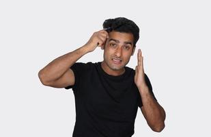 A man using derma roller for hair growth photo