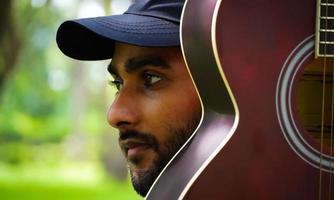 boy with red guitar close up eyes photo