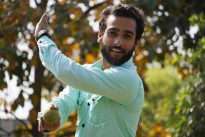 bowler man in with ball in cricket match photo