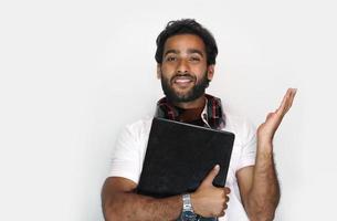 Handsome young man with laptop on white background - education concept photo