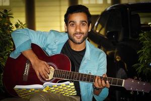 A man preparing for guitar practicing guitar in night photo