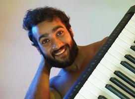 happy face man with electronic piano photo