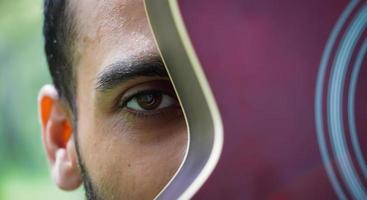 boy with red guitar close up eyes photo