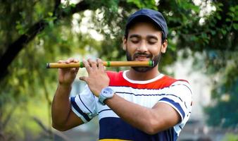 tocando la flauta bansuri instrumento de viento indio foto