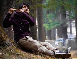 Blonde boy playing a flute photo