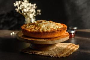 Apple pie with fresh fruits on a wooden table photo