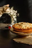 Apple pie with fresh fruits on a wooden table photo