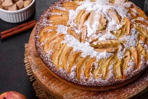 Apple pie with fresh fruits on a wooden table photo