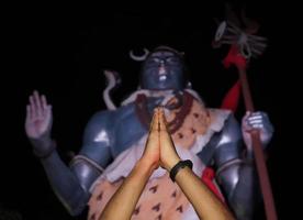 man doing prayer to Lord Shiva Statue on Ganges in Hardware .uttarakhand india. tourism