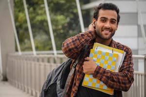 A confused boy smiling in camera and going for college photo