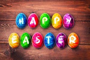 Easter background with colorful easter eggs on wooden background. photo