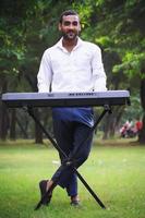 pianist in white shirt standing near playing piano photo