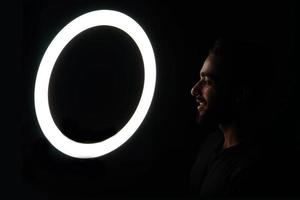 Young boy watching in ring light low light images photo