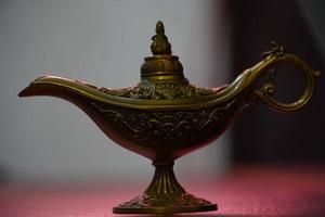 Aladdin magic lamp in sky with sun stock photo