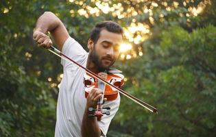 musician playing violin. at morning Music and musical tone concept. sun rays photo