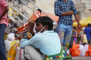 a poor man selling some items in market photo