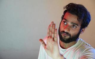 a man saying stop to someone using his hand photo