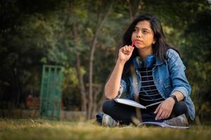 Young girl in thinking at college campus photo