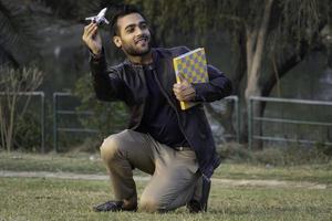 Study abroad concept man with aeroplane and books photo