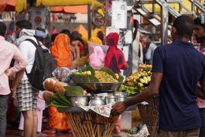 a poor seller selling some items in market photo