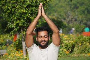 a man doing saurayanamaskaar yoga photo