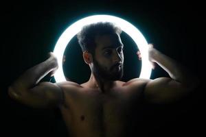 Young fit boy with ring light gym and fitness concept photo