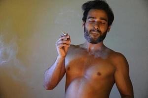 man smoking with cigarette photo