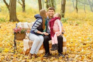 family walking in autumn park photo