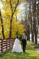 The bride and groom on the background of the autumn park. photo