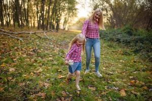 Father, daughter and mother walking outdoors. Happy family. photo