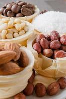 waffle basket with coffee beans, coconut, raisins, almonds, peanuts, hazelnuts and pine nuts photo