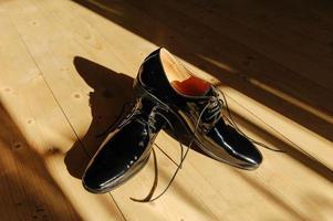 Black men's shoes in bright sunshine photo