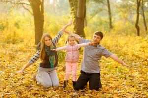 family walking in autumn park photo