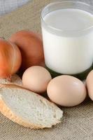 Chicken eggs with slices of bread on the table with milk photo