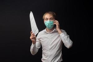 A young doctor studies papers and quarrels over the phone due to poor results. photo