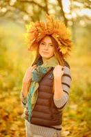 Portrait of a young girl in the autumn park. photo