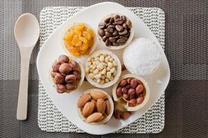 waffle basket with coffee beans, coconut, raisins, almonds, peanuts, hazelnuts and pine nuts photo