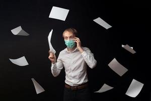 A young doctor studies papers and quarrels over the phone due to poor results. photo